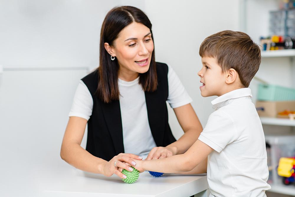 woman teaching young child