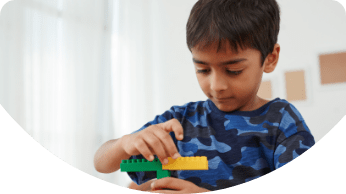 young child playing with legos
