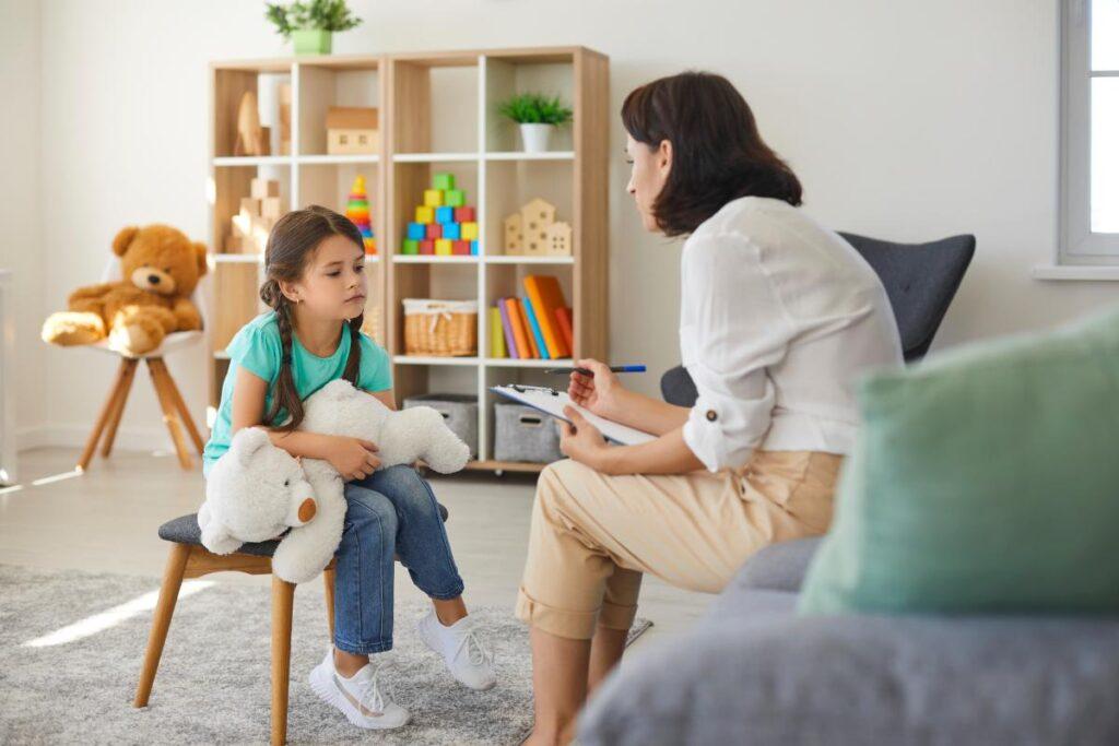 Counselor in playroom preparing a child for ABA Therapy