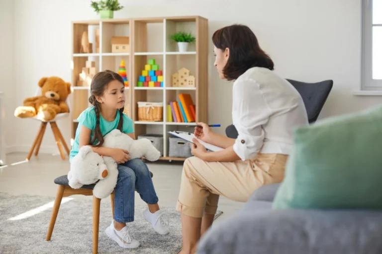 Counselor in playroom preparing a child for ABA Therapy