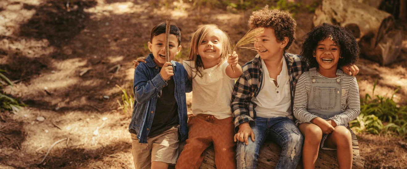 two children having a conversation on a bench demonstrating how to help children with autism make friends