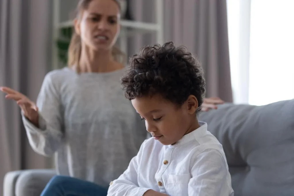 young boy at home with his mother on the couch demonstrating signs of autism in children